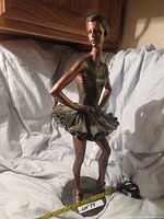 Front view showing ballerina in tutu, arms akimbo, detailed facial features and costume texture.