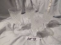 Set of 4 Waterford crystal sherry glasses in the Alana pattern with diamond cut design. Four glasses arranged upright.