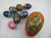 Group shot showing large papier-mâché egg and seven small decorated eggs