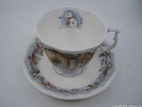 Cup and saucer together showing pattern and interior mouse image