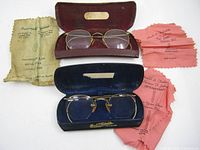 Overall lot showing both eyeglasses, cases and cloths