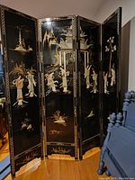 Full front view of four-panel screen showing inlaid figures and pagodas