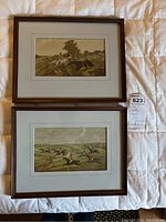 Two framed fox hunting prints side by side on white surface, showing entire lot contents.