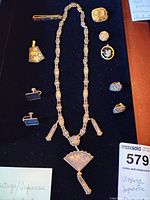 Photo of full vintage Japanese jewelry set on black velvet including necklace with detailed fan pendant, earrings, cufflinks, barrette, and additional pendant