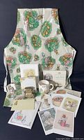 Overview of the assorted Beatrix Potter items including apron, writing papers, books, postcards, notecards, ornaments, and desk organizer.