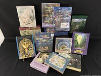 Photo showing multiple boxed notecard sets with art and cultural themes including Monet, Botticelli, Hockney, Tutankhamun, quilts, and museum references.