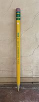 Full front view of giant pencil against wall