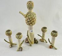 Overall view of the porcelain cordial set including one pineapple/asparagus pitcher and four matching cordial glasses
