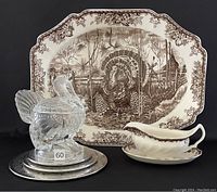 Complete set showing large turkey platter, glass turkey compote dish on EP trivets, and gravy boat with saucer against black background