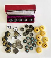 Full overview of all vintage buttons in the lot showing different types and styles including sterling turquoise, Bakelite, mother-of-pearl, black and silver decorative buttons.