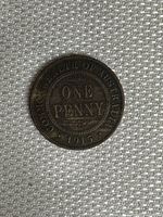 Front side of the 1915 Australian One Penny coin showing inscriptions and year clearly under good lighting.