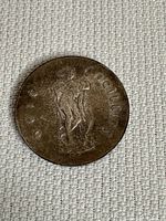 Front side of the 1966 silver Irish shilling coin showing a standing figure with harp and text 'SCILLIN'