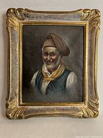 Frontal view of the oil on canvas portrait painting by Filippo Marantonio showing the man with brown hat and yellow neckerchief in a decorative gold frame.