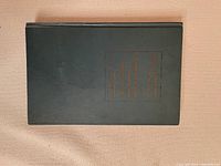 Front cover of a vintage book titled 'Standard Catalogue of Canadian Coins, Tokens and Paper Money' from 1922, Tenth Edition, showing the old dark green cloth with gold embossed text.