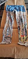 Front view of the leggings showing the full Jackson Hole ski map print with blue waistband.