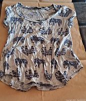 Front view of the T-shirt showing elephant pattern and round neckline