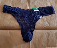 Front view of navy sea lace thong underwear with visible tag confirming size medium and new condition.