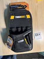 Front view of a black ToughBuilt Technician Tool Pouch with multiple compartments and yellow ToughBuilt label, showing the brand, design, and tool slots.