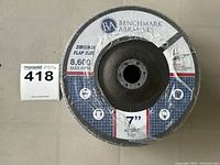 Photo shows five sealed 7-inch flap discs with Benchmark Abrasives label, zircona material, 40 grit, max 8600 RPM.
