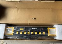 Photo showing the power center inside the packaging with visible 8 outlets and LED light panels.