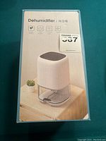 Front view of boxed dehumidifier showing product image and packaging design.