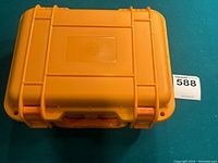 Top view of closed orange waterproof case for DJI Mavic Mini drone showcasing molded design and handle.