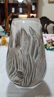 Front view of zebra art glass vase showing detailed zebra face design and shape.