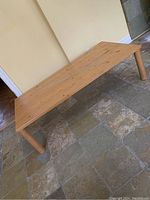 Full length view of the large pine coffee table showing clean varnish finish and simple Mid Century Modern design.
