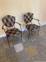 Pair of shieldback rattan chairs showing overall design, pattern and shape.