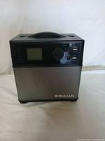 Front view of Ironman portable power generator showing control panel with screen, power buttons, 12V DC output, and USB ports