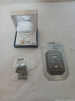 Sterling silver necklace with heart pendant in Timeless collection box, pack of stud earrings marked 925 sterling silver, and sealed smaller earring pack