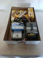 Box containing five water pumps, with four fountain pumps in boxes and one large metal-cased commercial pump visible.