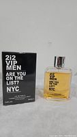 Black packaging box and clear bottle with amber liquid. Silver spray top visible. Bottle and box are branded with '2i2 VIP MEN ARE YOU ON THE LIST? NYC'.