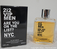 Photo shows the 2i2 VIP Men Eau de Parfum bottle alongside its black boxed packaging. Text on bottle and box reads 'ARE YOU ON THE LIST? NYC'. Bottle contains amber liquid and has a silver cap.