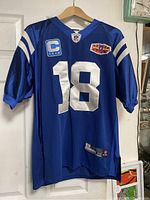 Front view of blue Indianapolis Colts football jersey, number 18, showing captain and 45th season patches