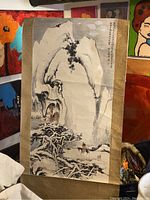 Photo of large painted Asian style scroll showing mountain, trees, rider on horseback, and calligraphy with fabric border.