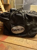 Black Dahon carry bag closed on wooden surface