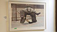 Full view of framed print showing hockey goalie crouched in front of net.