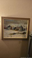 Full frontal view of framed barn landscape painting