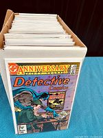 Box filled with vintage comic books stored in protective bags and backing boards.