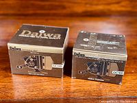 Original boxes for Daiwa GC120 and Goldcast III GC100 spincast reels showing brand and model details.