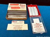 Both replacement stone sets displayed side by side in their original packaging showing the stones and instruction cards.