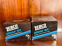 Photo of two original Zebco boxes for Omega 154 and Omega 164 spinning reels