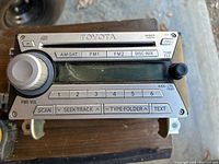 Front view of the Toyota FJ radio showing control buttons, tuning knob, and display screen.