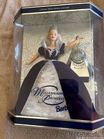 Front view of Barbie doll in original packaging, dressed in violet and silver gown with Millennium Keepsake ornament.