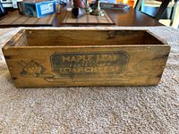 Front side of wooden cheese box with Maple Leaf Brand printed label on side