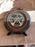 Front of the Hot Wheels Super Rally tire-shaped case featuring wheel design and logo