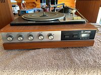Front view of Philips vintage stereo record player with control knobs and wood grain cabinet.