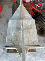 Top view of Sigma tile cutter showing metal base and handle, heavily worn surface.