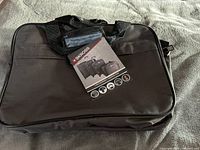 Front view of SKROSS laptop bag showing hang tag attached, highlighting brand and product images.